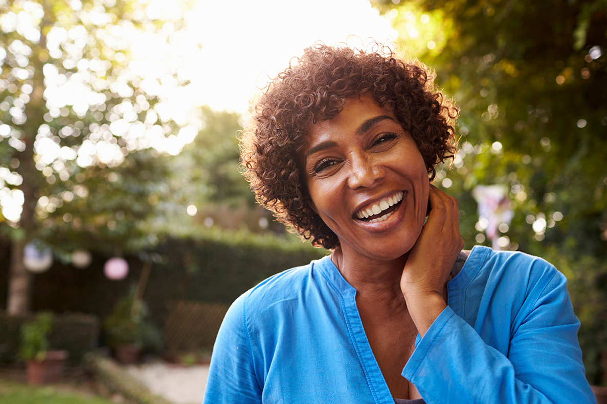 woman smiling after a Dental Implant Consultation in Golden, CO