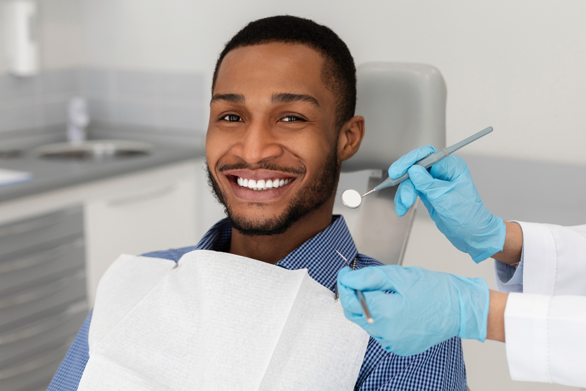 Man smiling at a dental exam in Golden CO