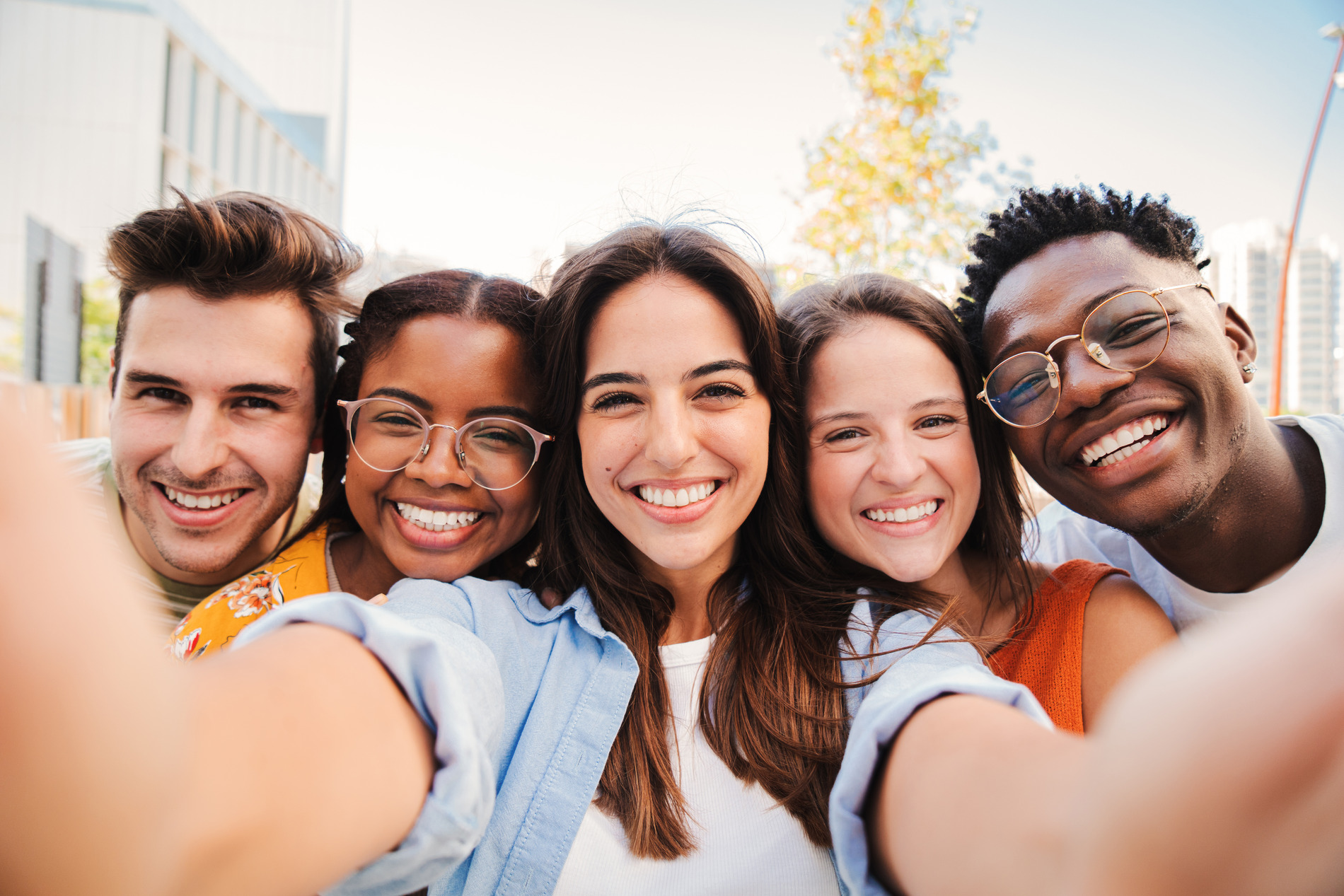 Friends smiling together happy with their new dental veneers in Golden CO